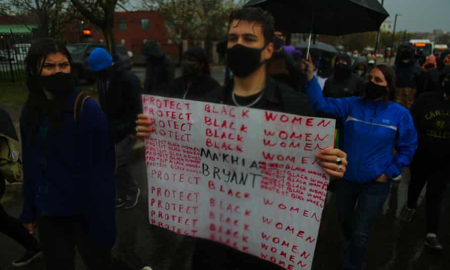 Demonstrators in masks with sign 'protect black women'